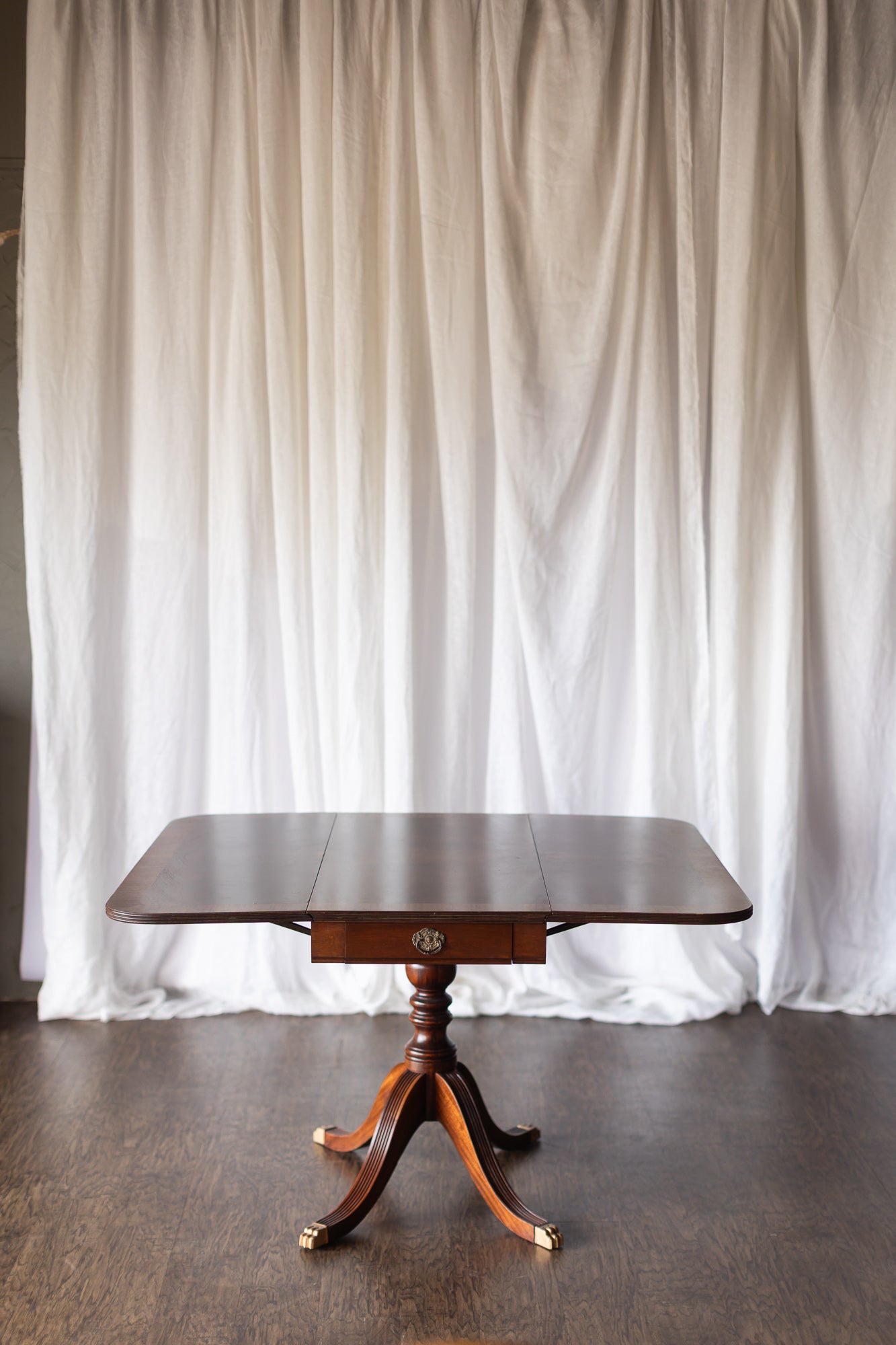 Mahogany Drop-Leaf Pedestal Table with Brass-Capped Feet