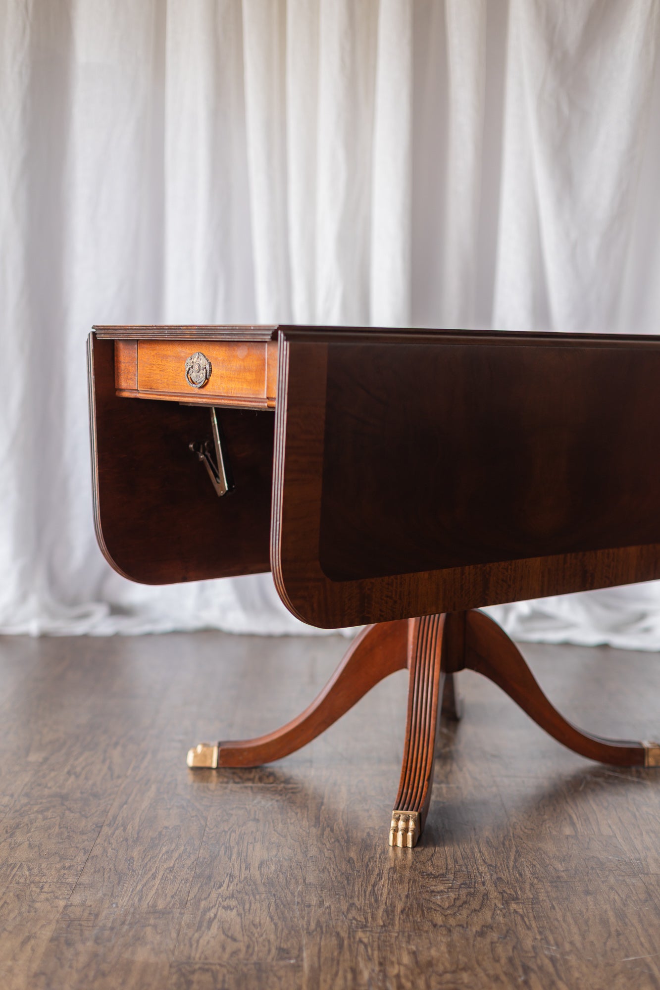 Mahogany Drop-Leaf Pedestal Table with Brass-Capped Feet