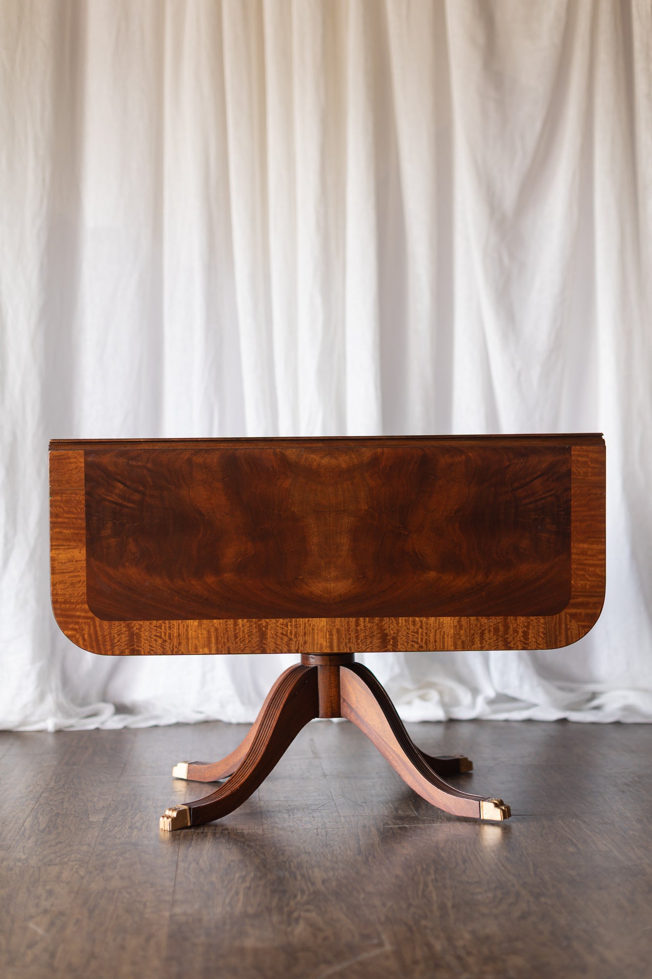 Mahogany Drop-Leaf Pedestal Table with Brass-Capped Feet